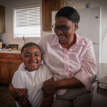 Betty and her Grandson smiling in their new home